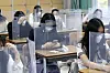 Senior students wait for class to begin with plastic boards placed on their desks at Jeonmin High School in Daejeon on May 20, as schools started reopening for high school seniors that week. It was their first day of class in the Spring semester, originally scheduled to begin in March. [AP/YONHAP]