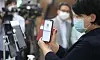A member of a church in central Seoul is scanning a QR code on her phone before entering the church on June 2 to register her personal information with the KCDC. Similar registration is required at large churches, cinemas, noraebangs (singing rooms) and restaurants in Seoul, Incheon and Daejeon as a pilot program of KCDC to enable accurate tracing in times of an outbreak. [OH JONG-TAEK]