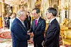 British King Charles III, left, greets Korean Prime Minister Han Duck-soo, center, during a reception at Buckingham Palace in London on Friday celebrating the coronation. [YONHAP]