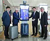 Incheon International Airport Corporation CEO Koo Bon-hwan and other delegates pose next to the country’s first smart scale installed Terminal 2 on Wednesday. The automated system not weighs luggage but it then send users updates on the progress of luggae as it is being loaded via an app. [YONHAP]