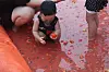 A child plays in the tomato pool at the Hwacheon Tomato Festival in Hwacheon County, Gangwon. [CHOI SEUNG-PYO]