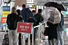 People wait in line to get tested for Covid-19 at Incheon International Airport Monday. [YONHAP]