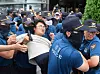 Police on Thursday apprehend a university student who attempted to break into the Japanese Embassy in central Seoul to protest Japan's discharge of the treated radioactive water from the ruined Fukushima Daiichi nuclear power plant. [YONHAP]