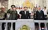 In this photo released by the state-controlled Korean Central News Agency on Friday, North Korean leader Kim Jong-un is seen standing on a dais overlooking the military parade that took place in Pyongyang on Thursday night to mark the 70th anniversary of the signing of the armistice that ended the 1950-53 Korean War. On the left stands Russian Defense Minister Sergei Shoigu, while Chinese Communist Party Politburo member Li Hongzhong stands on the right. [YONHAP]