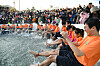 Visitors participate in bare hand fishing with their feet in water at the 2024 Hwacheon Sancheoneo Ice Festival. [HWACHEON COUNTY]