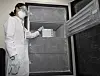 A medical staff member of a vaccination center in Ulsan stores Pfizer vaccines in a refrigerator on Wednesday. [NEWS1]