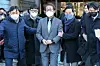 Superintendent of the Seoul Metropolitan Office of Education Cho Hee-yeon, center, exits the Seoul Central District Court in Seoul on Jan. 27, 2023, after being sentenced to 1 1/2 years in prison, suspended for two years, for his reinstatement of dismissed teachers. [NEWS1]