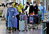 Arrivals from China are guided to PCR testing centers at Incheon International Airport on Wednesday. [YONHAP]