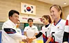Hana Financial Group Chairman and CEO Ham Young-joo, left, shakes hands with Team Korea athletes competing in goalball at the upcoming Paris 2024 Paralympic Games during a visit to the Icheon National Training Center in Gyeonggi on Tuesday. [HANA FINANCIAL GROUP]