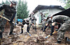 Soldiers on Tuesday clean up a landslide that occurred at a vacation resort in Yongin, Gyeonggi, due to heavy rains. [YONHAP]