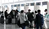 People stand in front of travel agency counters in Incheon International Airport on March 18. [NEWS1]