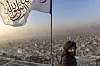 FILE-- A member of the Taliban with the group’s flag over the Kabul skyline, Dec. 7, 2021. Afghanistan has remained largely isolated since the Taliban seized power nearly four years ago, despite subtle signs of increased cooperation with countries like China and India. (David Guttenfelder/The New York Times)