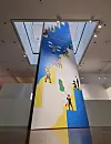 Joo Ho-min's digital print of ″What Are They Doing down the Stairs?″ (2021) is based on his father's painting ″Spring Rain Descending a Staircase″ (1980), featuring popular characters from some of his previous webtoons. [JEON TAE-GYU]
