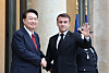 Korean President Yoon Suk Yeol, left, and French President Emmanuel Macron shake hands ahead of a bilateral summit in Paris on Friday. Yoon’s three-day trip to France comes as he is making final efforts to drum up support for hosting the World Expo 2030 in Busan. [JOINT PRESS CORPS]