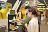 Models pose in front of a robotic waiter at Shinsegae's No Brand Burger branch in Yeoksam-dong, southern Seoul. Shinsegae Food on Tuesday said it has opened a fully automated burger joint where the hamburgers including buns and patties are made on a robotic assembly line. [SHINSEGAE FOOD]