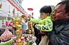 A child pours water over a golden Buddhist statue at an event to celebrate upcoming Buddha's birthday in Jongno District in central Seoul on April 27. Buddha's birthday falls on May 5 this year. [YONHAP]