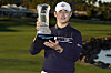 Kim Si-woo holds the winner's trophy at the end of The American Express tournament in La Quinta, California, on Sunday. [AP/YONHAP]