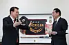 Korean President Yoon Suk Yeol, left, chats with Japanese Prime Minister Fumio Kishida, in front of U.S. President Joe Biden’s gift of baseball memorabilia from Yoon’s state visit in late April at the Yongsan presidential office in central Seoul Sunday during their bilateral summit. [PRESIDENTIAL OFFICE]