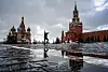 A man gestures as he walks along the Red Square in front of the Saint Basil cathedral and Spasskaya tower in Moscow on March 8. [YURI KADOBNOV/AFP/YONHAP]