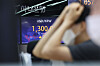 An electronic display board at Hana Bank in central Seoul shows the won touching 1,300 won per dollar on Thursday. [YONHAP]
