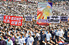 In this photo released by the Korean Central News Agency, North Koreans in Pyongyang participate in a mass anti-U.S. rally on Sunday, which marked the 73rd anniversary of the outbreak of the Korean War. The caption on the large poster reads ″All of the mainland United States is within our range,″ referring to the North's intercontinental ballistic missiles. [YONHAP]