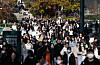 Students stream out of an exam site after completing the essay test for the 2025 academic year early admission, held on Sunday afternoon at Ewha Womans University in Seodaemun District, western Seoul. [NEWS1]