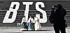 Tourists take a photo in front of a promotion for BTS's new album, 'Arirang,' at the Sejong Center for the Performing Arts in Jongno District, central Seoul, on Jan. 22. [YONHAP]