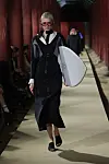 A model walks down Geunjeongjeon's haenggak, a roofed corridor, carrying a surf board for the latest Gucci 2024 Cruise collection show on May 16. [GUCCI]