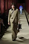 A model walks down Geunjeongjeon's haenggak, a roofed corridor, carrying a handbag that looks like a skateboard, for the latest Gucci 2024 Cruise collection show on Tuesday. [GUCCI]