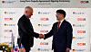 OCI Holdings Chairman Lee Woo-hyun, right, and CubicPV CEO Frank Van Mierlo shake hands during a long-term supply contract signing ceremony in Massachusetts on Monday. [OCI HOLDINGS]