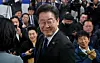 Democratic Party leader Lee Jae-myung smiles after securing victory for Incheon's Gyeyang-B constituency at his election war room on Thursday. [JOINT PRESS CORPS]