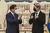 BTS member J-Hope, right, gives President Moon Jae-in a thumbs up at a ceremony appointing the K-pop boy band as special presidential envoys attended by senior Blue House officials and Big Hit Music and HYBE executives Tuesday. [JOINT PRESS CORPS]