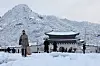People walk the snow-covered streets of Jongno District, central Seoul on Wednesday. [NEWS1]