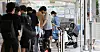 People wait in line to get tested for Covid-19 in front of a center in Mapo District, western Seoul on Thursday. [YONHAP]