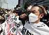 Members of an association of university students shave their heads in protest of Japan’s decision to release contaminated water into the Pacific Ocean in front of the Japanese Embassy in central Seoul Tuesday. [NEWS1]