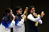From left, women's 10-meter air pistol silver medalist, Korea's Kim Ye-ji, gold medalist, Korea's Oh Ye-jin, and bronze medalist, India's Manu Bhaker, take a selfie on the podium during the Paris 2024 Olympics on Sunday. [SAMSUNG ELECTRONICS/GETTY IMAGES]