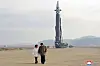 North Korean leader Kim Jong-un, right, holds hands with his daughter as they prepare to watch the launch of a new Hwasong-17 intercontinental ballistic missile (ICBM) at Pyongyang International Airport Friday in a photo released by the North's official Korean Central News Agency (KCNA) Saturday. It is the first time one of Kim’s children has been revealed to the public. [KCNA]