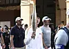 Jin carries the Olympic torch in Paris on July 14. [NEWS1]