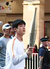 Jin carries the Olympic torch in Paris on July 14. [NEWS1]