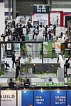 Visitors look around exhibition booths at the 2024 Korea Build Week, a construction trade show, held at Coex in Gangnam District, southern Seoul, on Wednesday. [YONHAP]