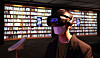A visitor wears a VR device to experience a library of the future at the National Library of Korea’s new exhibition “The Live Library” that runs until May 31. [YONHAP]