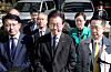 Democratic Party (DP) Chairman Lee Jae-myung, center, is choked up as he speaks to reporters as prosecutors conduct a raid of a think tank located in his party’s headquarters in Yeouido, western Seoul, Monday. [JANG JIN-YOUNG]