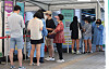 People line up at a Covid-19 testing center in Yongsan District, central Seoul, on Sunday, as cases again passed 10,000. [NEWS1]