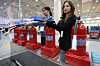 Booth officials demonstrate fire extinguishers during Housing Brand Fair 2025 and Tool & Safety Show 2025 at Coex in Gangnam District, southern Seoul, on the morning of Jan. 22. [YONHAP]