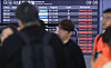 An electronic display at Jeju Airport shows flights cancelled due to strong winds on Tuesday morning. [YONHAP]
