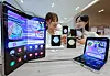 Models hold Samsung Electronics' new Galaxy Z Flip 5 and Fold 5 devices at the office of KT in central Seoul, the country's leading mobile carrier, a day before the opening of the models' pre-order. [YONHAP]