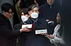 Former Justice Minister Cho Kuk, center, speaks to the press on Friday outside the Seoul Central District Court in Seocho District, southern Seoul, after the court sentenced him to two years in prison. [YONHAP]