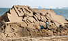 A foreign artist creates sand artwork of the K-pop boy band BTS at Haeundae Beach in Busan on Monday. The 2023 Haeundae Sand Festival, themed 'Expo Sand Sea for the Future of 2030,' will be held from Friday to Monday at Haeundae Beach and Gunam-ro Haeundae Square. [YONHAP]