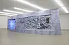 Placed in the middle of the exhibition space, this installation serves as a memorial as well as a crematorium. Note the details of the ventilation fans and a mural of Lee Dae-wang, the main protagonist of Ryu's artworks. [FONDATION D'ENTREPRISE HERMES]
