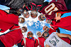 American football players huddle up during a practice session at Jukwang public field in Goseong, Gangwon on Tuesday. Players from Gangwon University, Sungkyunkwan University, the University of Seoul and Hallym University have been playing together at a joint training camp in Goseong since Aug. 4. [YONHAP]